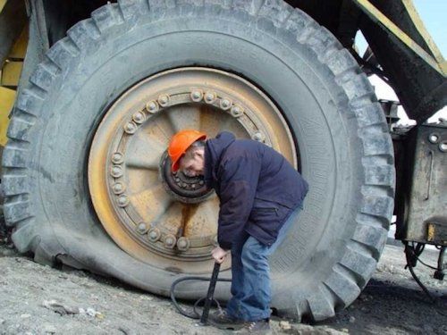 pumping up car tire with bike pump